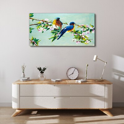 Obraz canvas Vtáky na kvitnúcej vetve