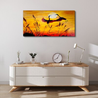 Obraz canvas Tancujúce žeriavy pri západe slnka