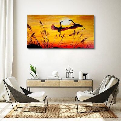 Obraz canvas Tancujúce žeriavy pri západe slnka