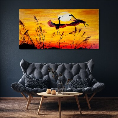 Obraz canvas Tancujúce žeriavy pri západe slnka