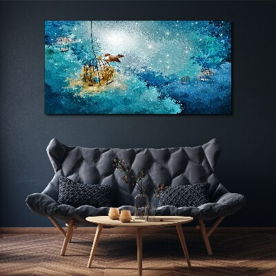 Obraz canvas Vták v klietke proti oblohe