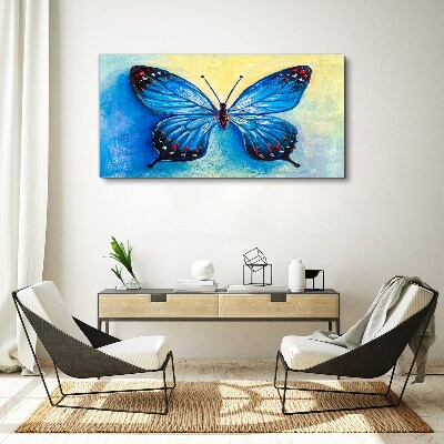 Obraz canvas Modrý motýľ na abstraktné pozadí