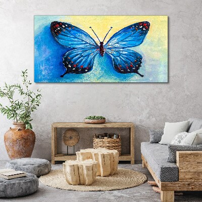 Obraz canvas Modrý motýľ na abstraktné pozadí