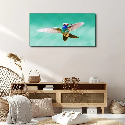 Obraz canvas Kolibrík v modrom pozadí
